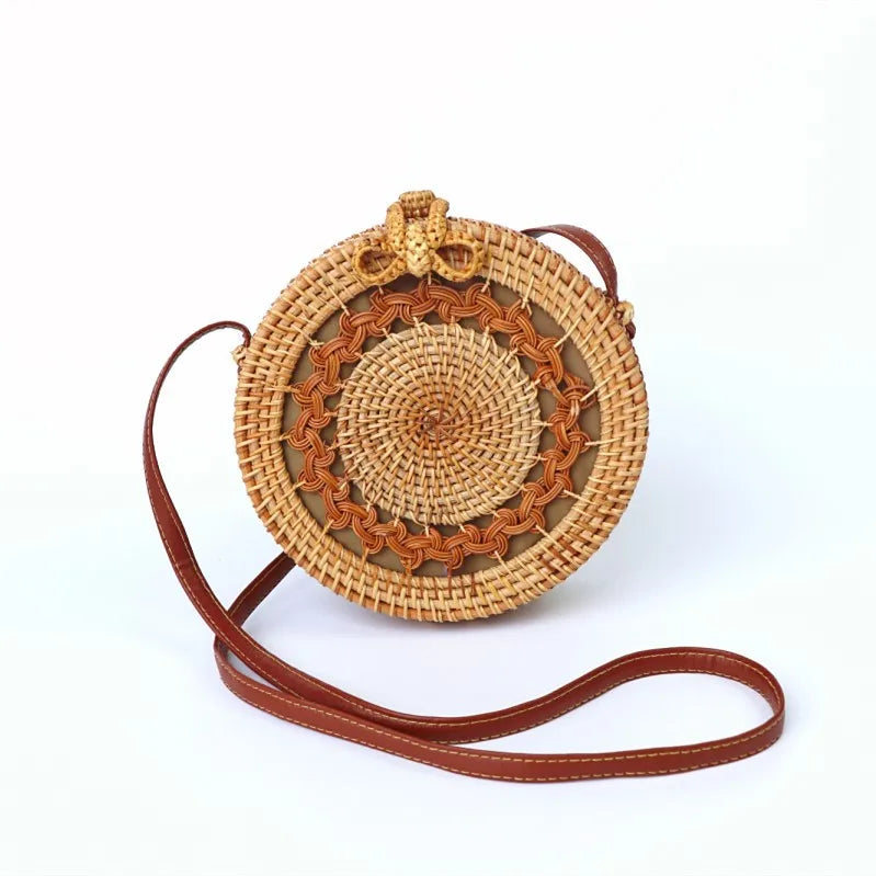 “Women’s handwoven rattan crossbody beach bag on white background”